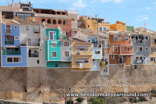 houses overhanging riverbed